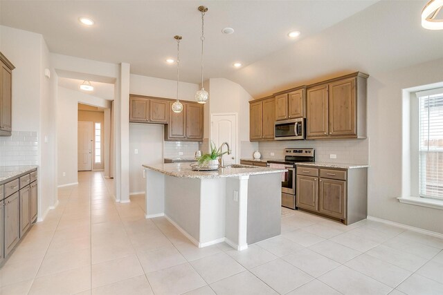 6328 Red Cliff Dr, Fort Worth, TX 76179 - kitchen with stainless steel appliances, backsplash, light stone countertops, vaulted ceiling, and light tile patterned flooring
