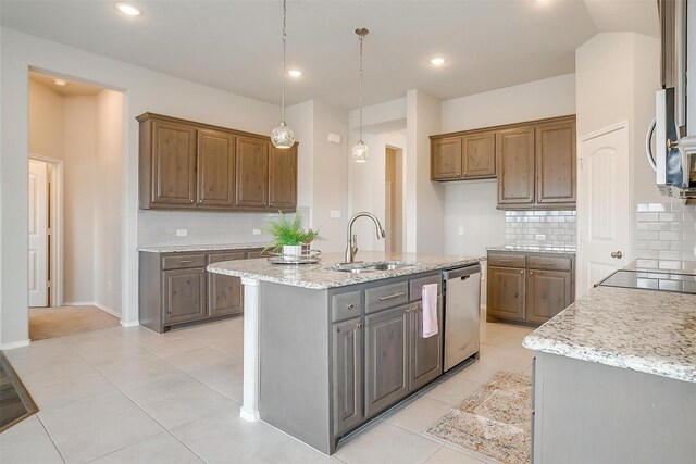 6328 Red Cliff Dr, Fort Worth, TX 76179 - kitchen featuring a sink, stainless steel appliances, decorative backsplash, light stone counters, and recessed lighting
