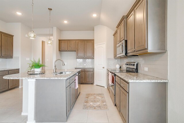 6328 Red Cliff Dr, Fort Worth, TX 76179 - kitchen featuring stainless steel appliances, a sink, light tile patterned floors, light stone countertops, and recessed lighting