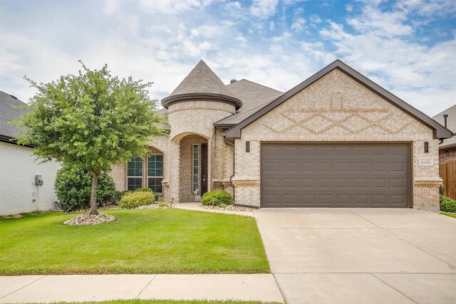 6328 Red Cliff Dr, Fort Worth, TX 76179 - french country style house with brick siding, an attached garage, a front lawn, and driveway
