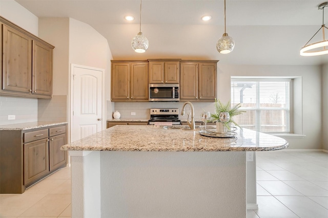 6328 Red Cliff Dr, Fort Worth, TX 76179 - kitchen with stainless steel appliances, a sink, light tile patterned flooring, light stone counters, and decorative backsplash