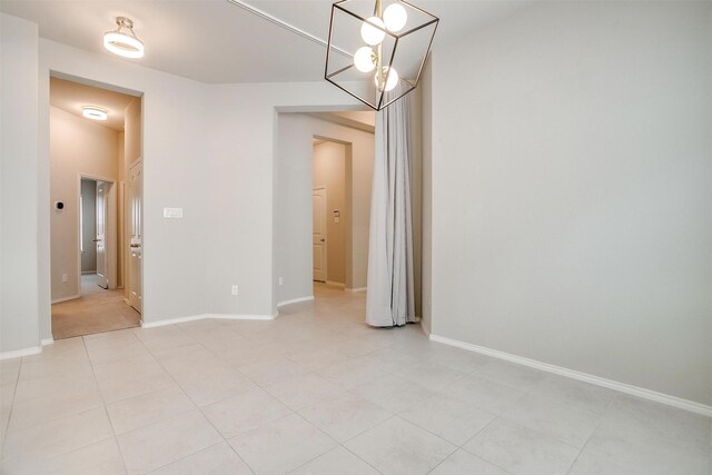 6328 Red Cliff Dr, Fort Worth, TX 76179 - empty room with a chandelier, light tile patterned floors, and baseboards