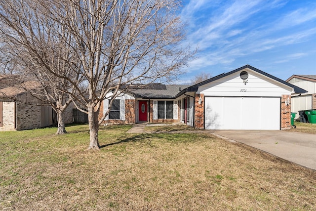 ranch-style house featuring driveway, roof mounted solar panels, a front yard, an attached garage, and brick siding