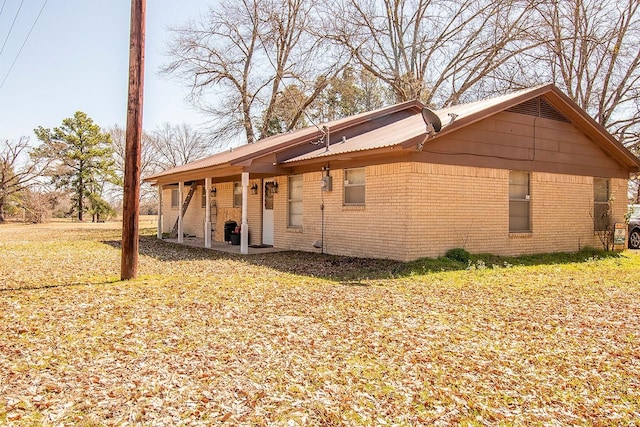 back of property with a patio and brick siding