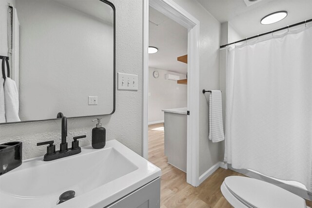 88 Live Oak St, Alvarado, TX 76009 - bathroom with baseboards, a shower with curtain, toilet, vanity, and wood finished floors