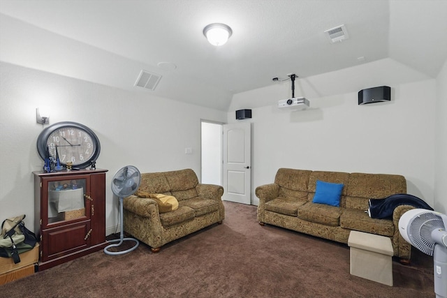 living room with vaulted ceiling, dark colored carpet, and visible vents