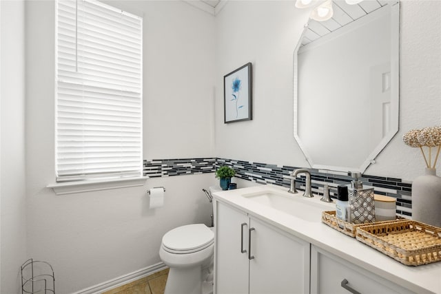 bathroom featuring tile patterned flooring, backsplash, toilet, and vanity