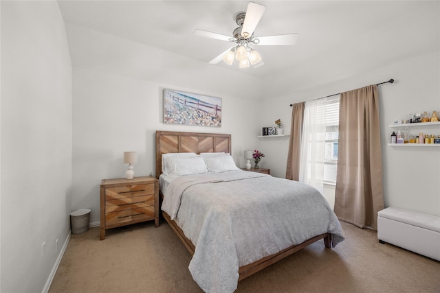 bedroom with light colored carpet, baseboards, and ceiling fan