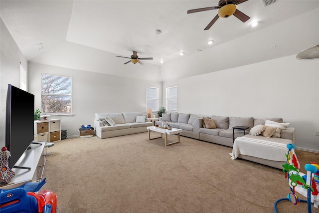 living area featuring visible vents, lofted ceiling, a ceiling fan, carpet floors, and baseboards