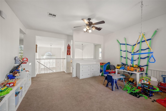 game room featuring visible vents, light carpet, and a ceiling fan