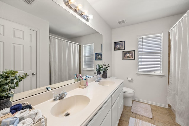 full bathroom featuring tile patterned floors, visible vents, double vanity, and a sink