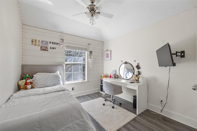 bedroom with baseboards, lofted ceiling, wood finished floors, and a ceiling fan