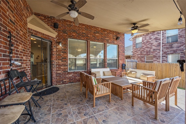 view of patio with an outdoor hangout area, a ceiling fan, and fence