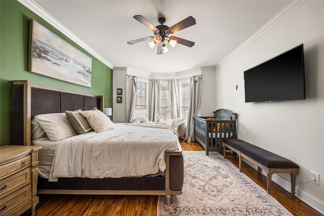 bedroom with baseboards, a ceiling fan, ornamental molding, and dark wood finished floors