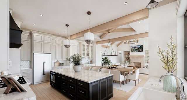 189 Caddo Trl, Corsicana, TX 75109 - kitchen featuring decorative backsplash, built in fridge, a sink, a notable chandelier, and dark cabinets