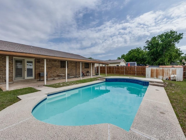 view of pool featuring a fenced in pool, a patio area, fence, and french doors