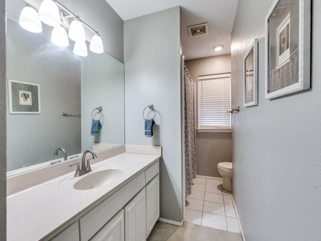 full bathroom featuring vanity, visible vents, a textured ceiling, tile patterned floors, and toilet