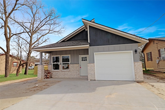 view of front of property with board and batten siding, concrete driveway, and a garage