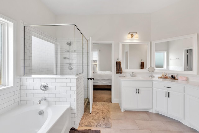 full bathroom with a garden tub, ensuite bathroom, tile patterned flooring, tiled shower, and vanity