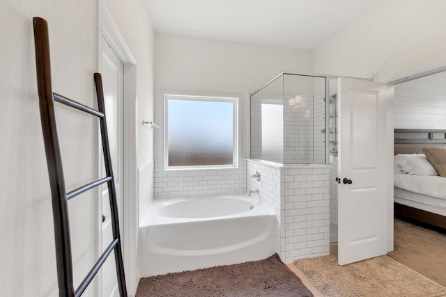 ensuite bathroom featuring ensuite bath, a garden tub, and a shower stall