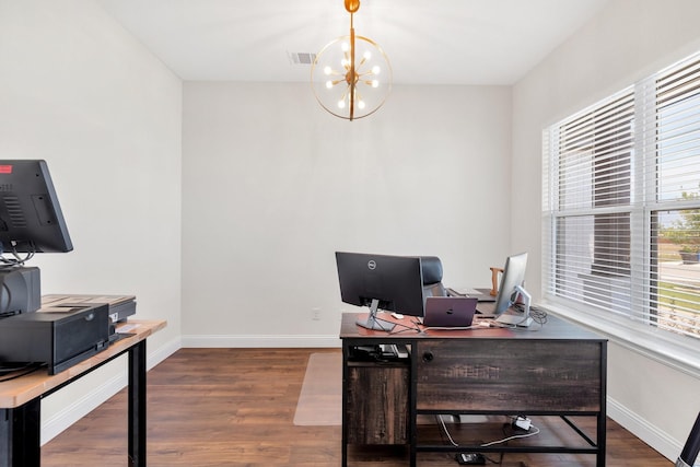 office space with wood finished floors, baseboards, visible vents, and a chandelier