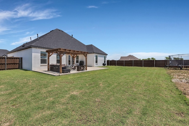 back of house featuring a pergola, a trampoline, a fenced backyard, a yard, and a patio area