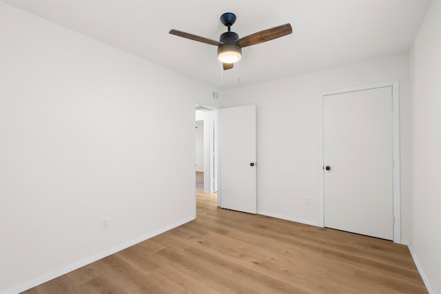 unfurnished bedroom featuring visible vents, a ceiling fan, light wood-type flooring, and baseboards