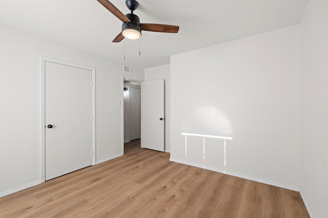 unfurnished bedroom featuring visible vents, baseboards, light wood-style flooring, and a ceiling fan