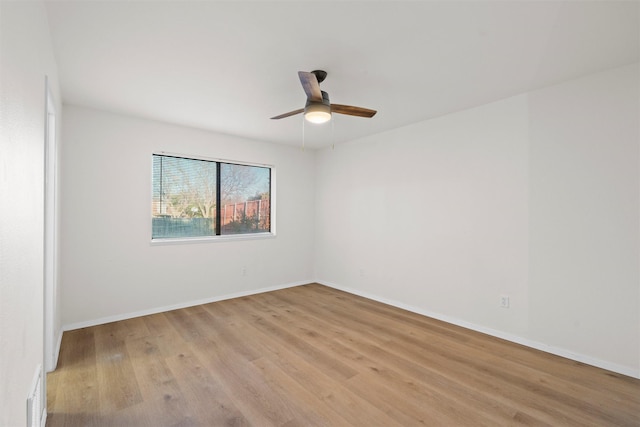 empty room with baseboards, light wood-style flooring, and a ceiling fan