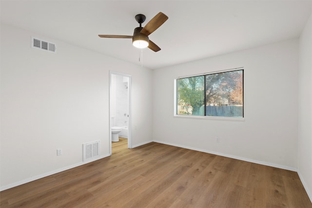 unfurnished room featuring baseboards, visible vents, light wood finished floors, and ceiling fan