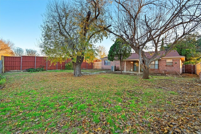 view of yard with a fenced backyard