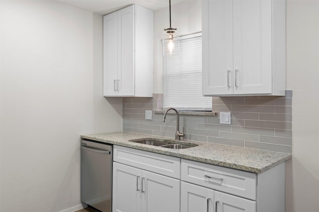 kitchen featuring dishwasher, tasteful backsplash, white cabinetry, and a sink