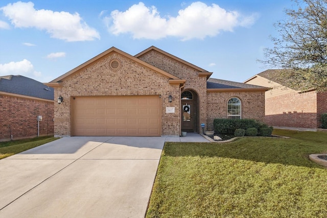 view of front facade with driveway, a front lawn, roof with shingles, an attached garage, and brick siding