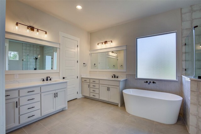 bathroom with plenty of natural light, a stall shower, and a sink