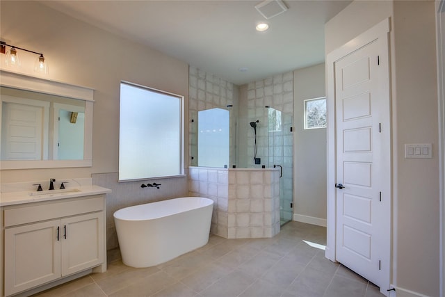 bathroom featuring visible vents, a shower stall, tile patterned floors, vanity, and a freestanding bath