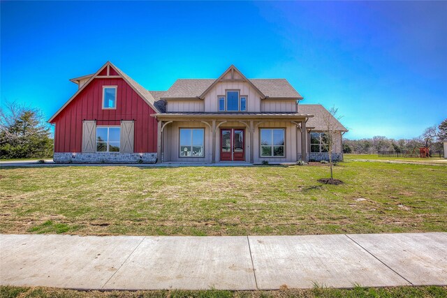 modern farmhouse featuring french doors, board and batten siding, and a front yard