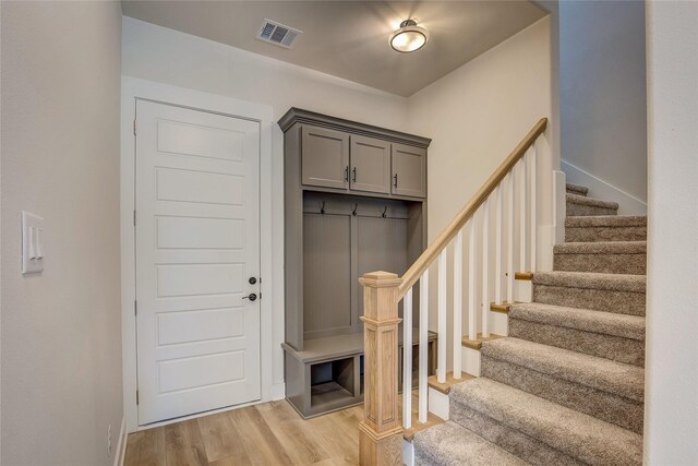 mudroom featuring baseboards, light wood-style floors, and visible vents