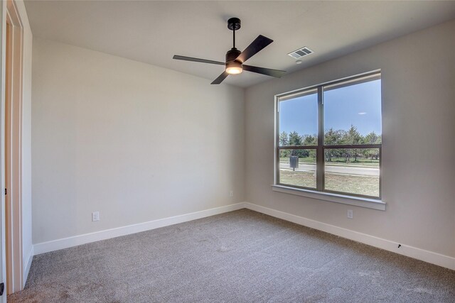 carpeted empty room featuring a ceiling fan, baseboards, and visible vents