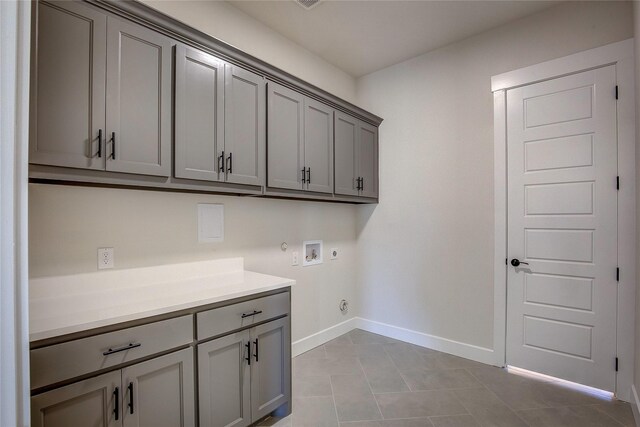 washroom with hookup for an electric dryer, hookup for a washing machine, baseboards, gas dryer hookup, and cabinet space