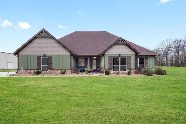 craftsman-style house featuring board and batten siding, a shingled roof, and a front yard