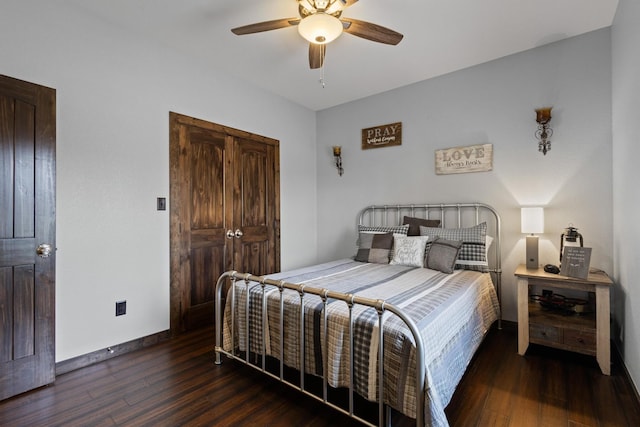 bedroom with wood finished floors, baseboards, and a ceiling fan