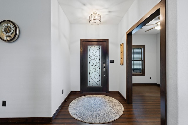 entrance foyer with baseboards, wood finished floors, and ceiling fan with notable chandelier