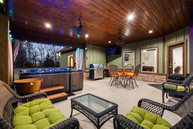view of patio / terrace with a hot tub, a ceiling fan, grilling area, an outdoor living space, and outdoor dining space