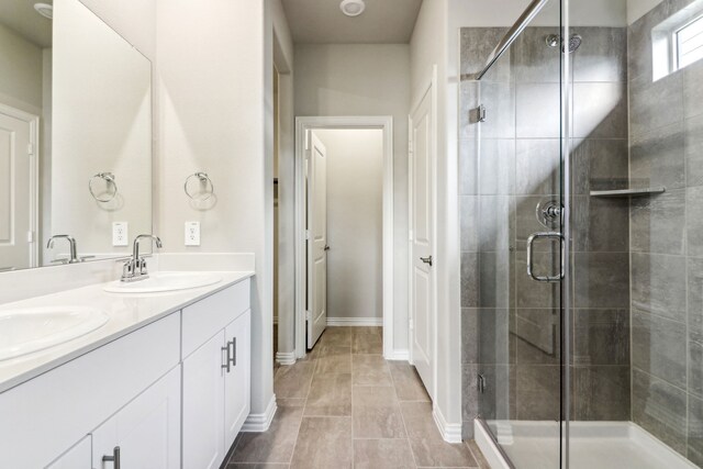 718 Caraway Dr, Princeton, TX 75071 - bathroom with a shower stall, double vanity, and baseboards