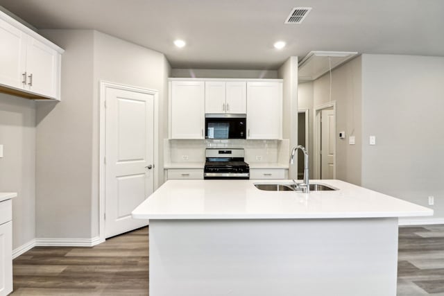 718 Caraway Dr, Princeton, TX 75071 - kitchen featuring stainless steel appliances, a sink, wood finished floors, white cabinets, and light countertops