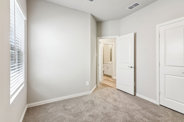 718 Caraway Dr, Princeton, TX 75071 - unfurnished bedroom featuring multiple windows, carpet flooring, and baseboards