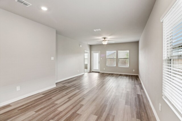718 Caraway Dr, Princeton, TX 75071 - empty room featuring wood finished floors, a ceiling fan, baseboards, and recessed lighting
