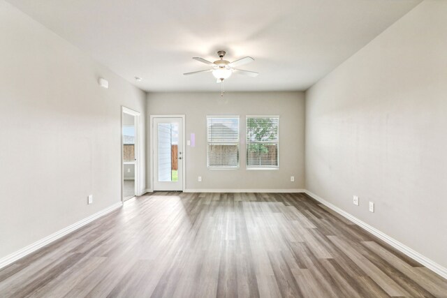 718 Caraway Dr, Princeton, TX 75071 - unfurnished living room featuring ceiling fan, wood finished floors, and baseboards