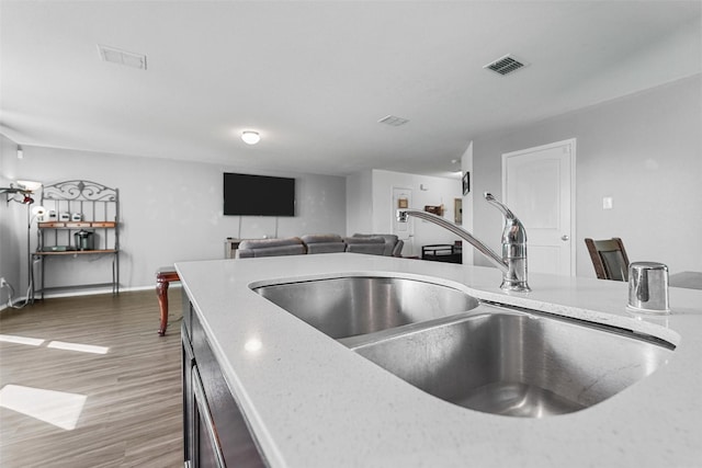 5625 Mcclelland St, Forney, TX 75126 - kitchen featuring a sink, wood finished floors, baseboards, and light stone countertops