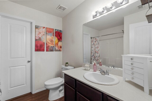 5625 Mcclelland St, Forney, TX 75126 - full bath with vanity, wood finished floors, a shower with shower curtain, and toilet